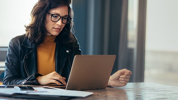 Woman-with-glasses-working-on-laptop