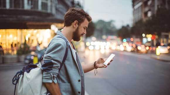 Man looking at phone before crossing the street Man looking at phone before crossing the street