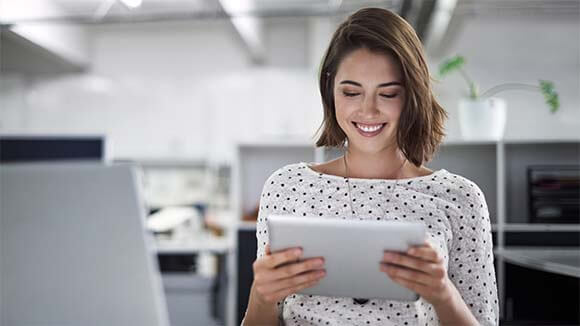 Woman on tablet Woman consulting her LinkedIn profile on her tablet