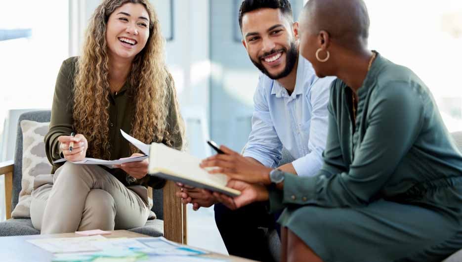 Happy business people smile during a planning meeting in a startup marketing agency office. Diversity, collaboration and teamwork in a healthy work environment in an international advertising company.