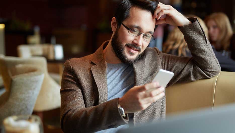 Young man texting a message on his phone